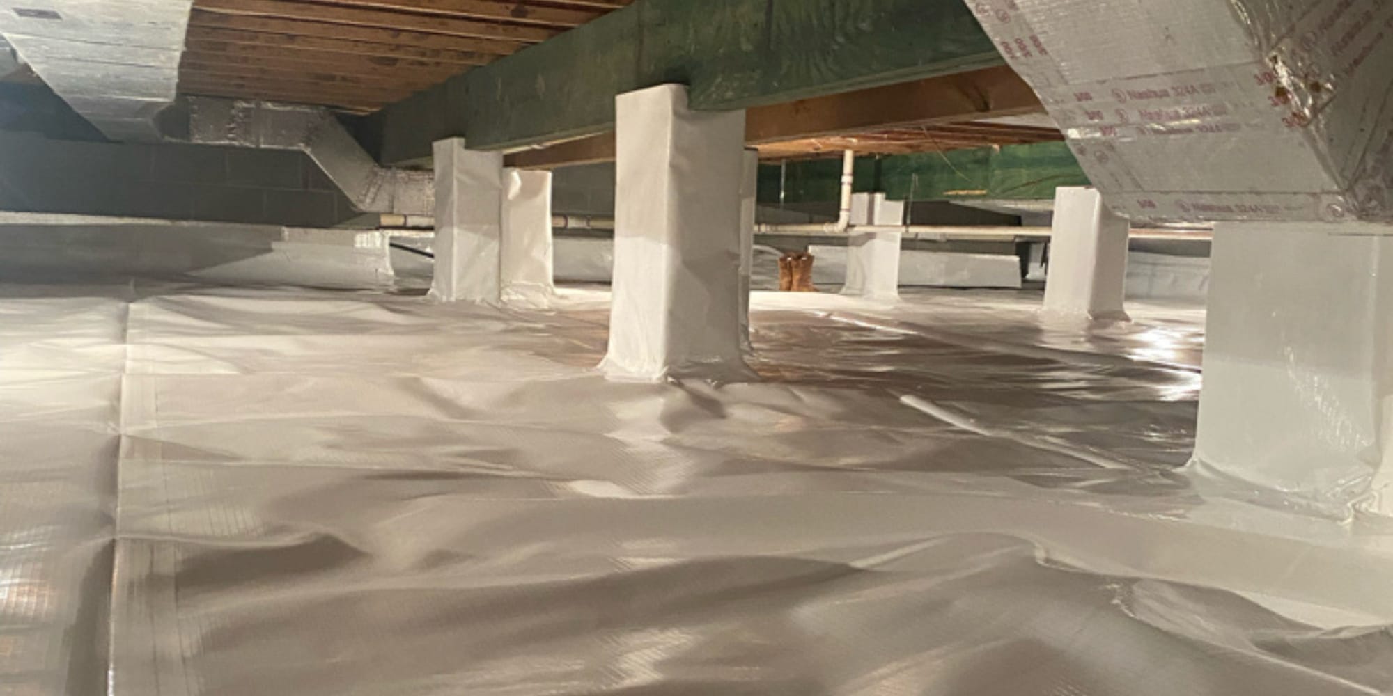 A crawl space sealed with vapor barrier over the floor and walls, showing the benefits of sealing crawl space in Northern, VA.