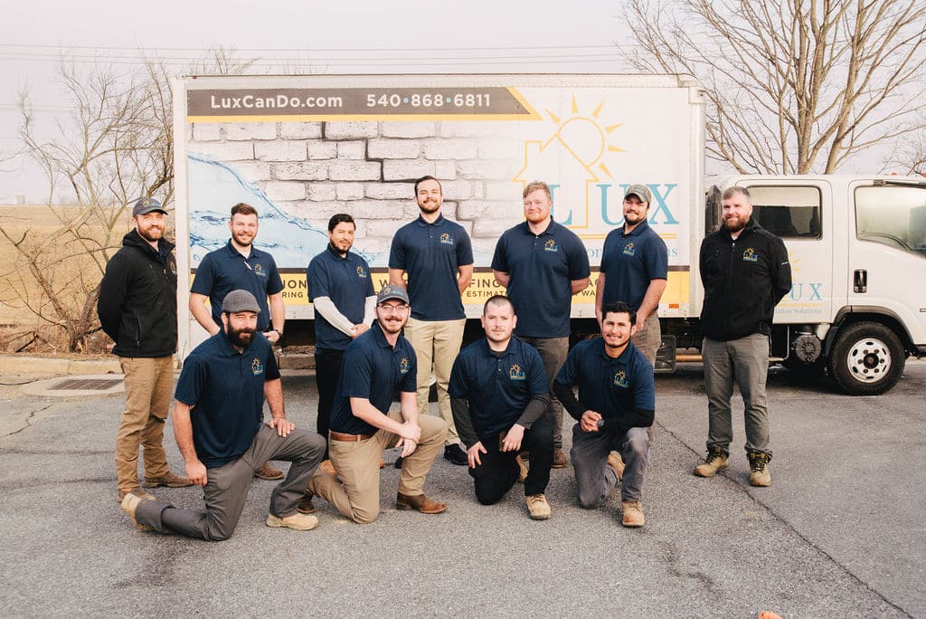 LUX foundation repair experts team in Northern VA, standing by their service truck, serving homeowners for foundation problems.