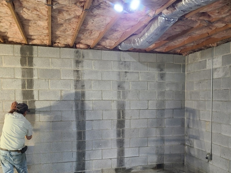High-strength structural epoxy applied to concrete block foundation wall before carbon fiber strap installation in Winchester, VA.