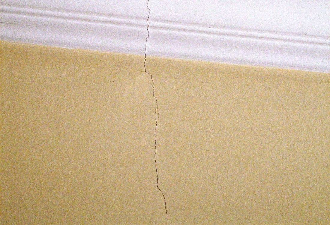 A thin hairline drywall crack caused by normal seasonal movement, not a drywall crack that keeps coming back in Fairfax, VA.