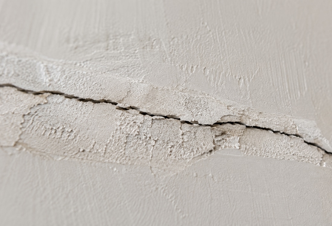A drywall repair that failed, with the crack reopening along the same line in Alexandria, VA.