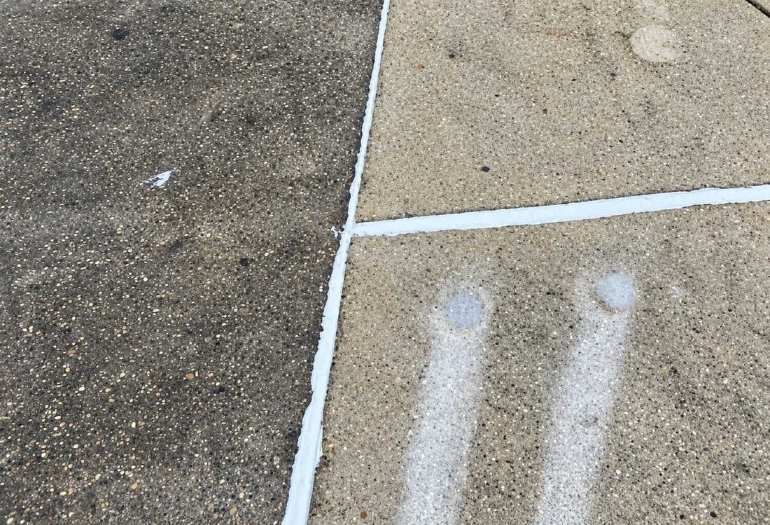 Sealed crack in a concrete driveway in Alexandria, VA, showing localized crack repair.