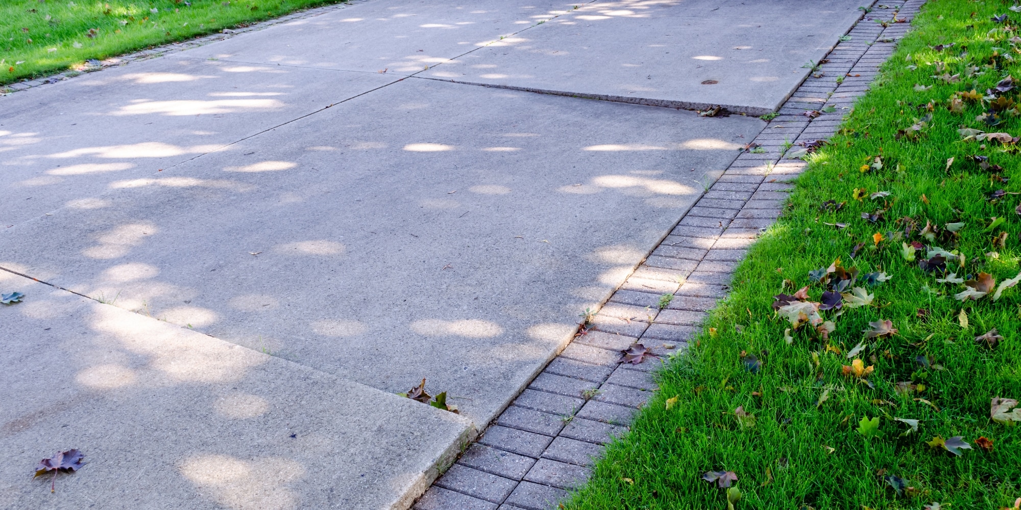 Cracked concrete driveway showing a need for concrete driveway crack repair in Northern VA.
