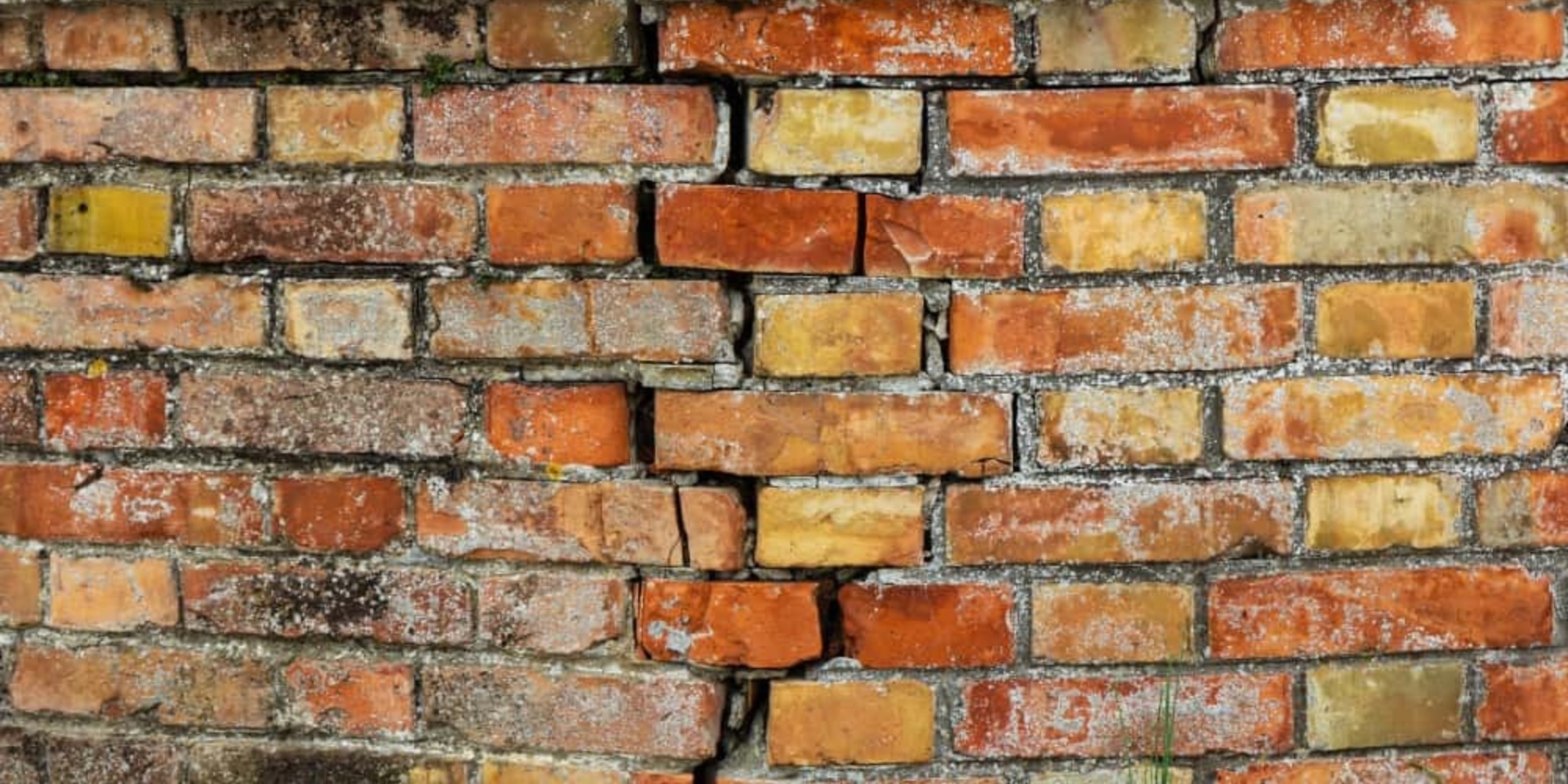 Cracks in brick mortar on a brick home exterior wall showing mortar joint deterioration in Northern Virginia.