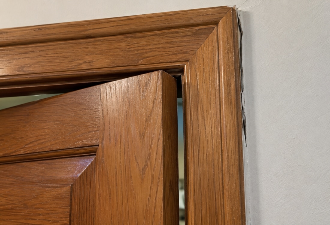 A visible gap at a door frame, showing misalignment that can return even after a door has been repaired in Winchester, VA.