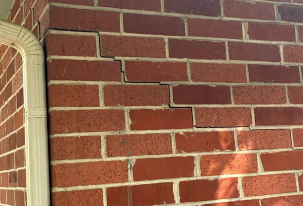 Visible foundation wall crack showing settlement that needs evaluation of existing foundation before home addition in Winchester, VA.