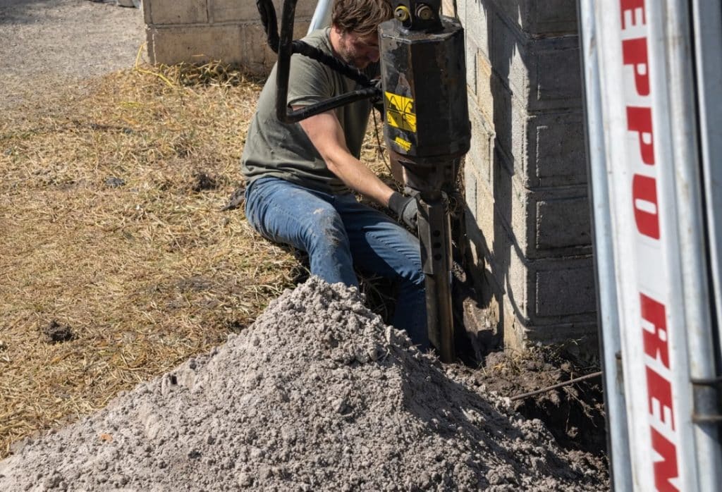 Repair expert reinforcing a foundation with support piers after evaluation of existing foundations before home addition in Bristow, VA.