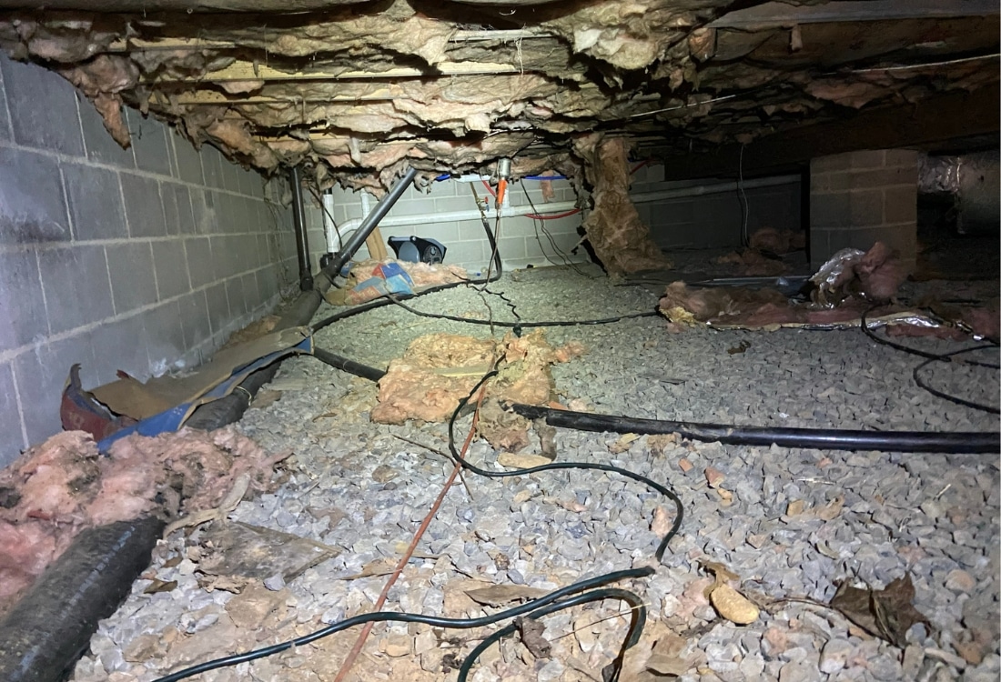 Bare dirt and gravel floor letting ground moisture rise into the space, sign needs a vapor barrier in crawl space in Winchester, VA.