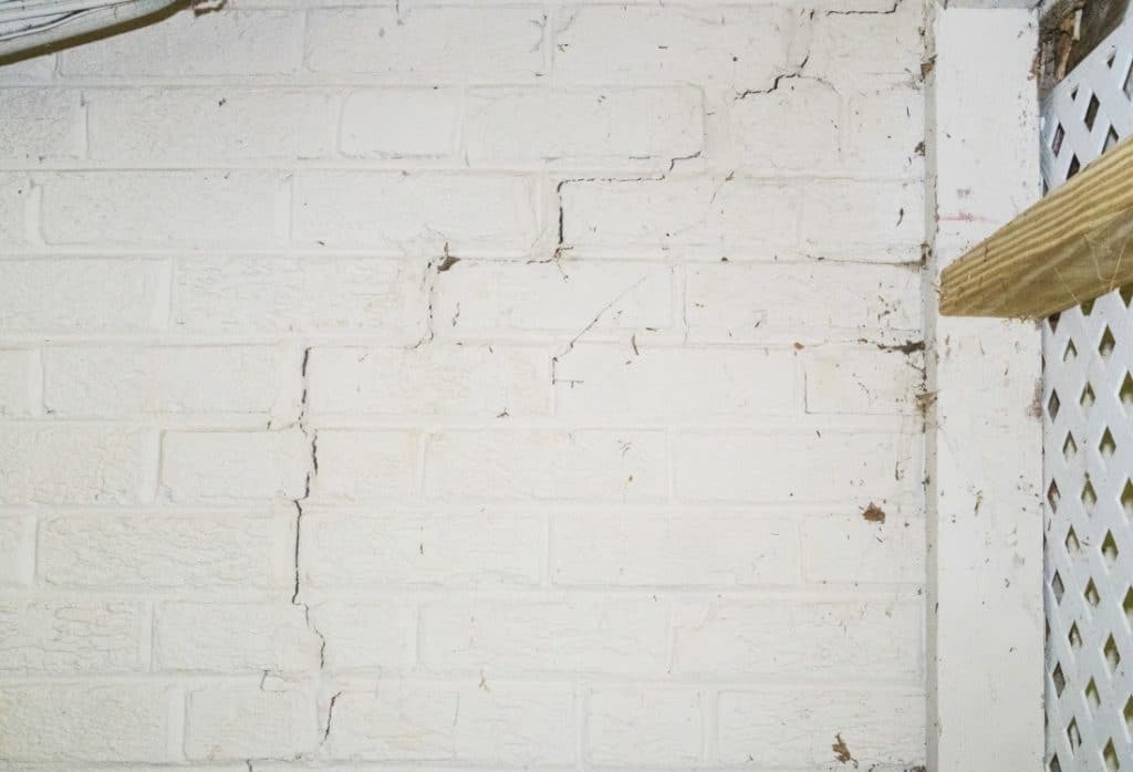Foundation wall cracks due to movement of expansive soil causing foundation damage in Ashburn, VA.
