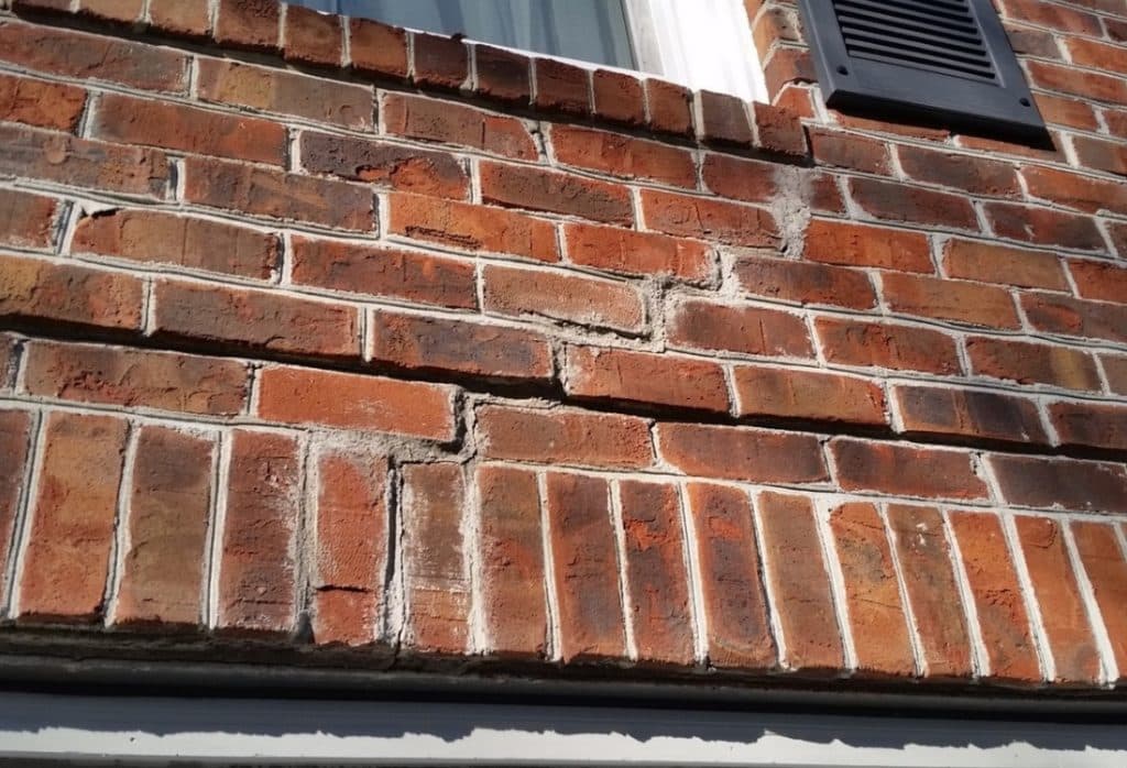Horizontal mortar crack below a window on a brick exterior wall in Winchester, VA.