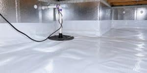 Installed vapor barrier and sump pump system showing the benefits of crawlspace waterproofing in Northern Virginia home.